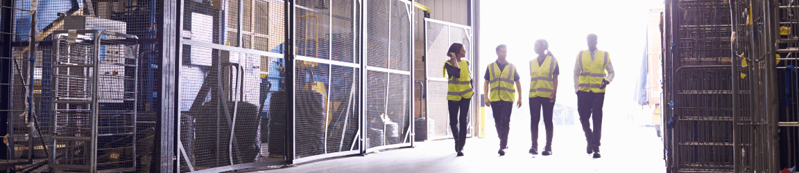 Workers wearing yellow vests walk into warehouse