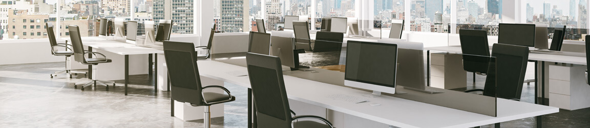 Empty shared office space with chairs, computers, and tables