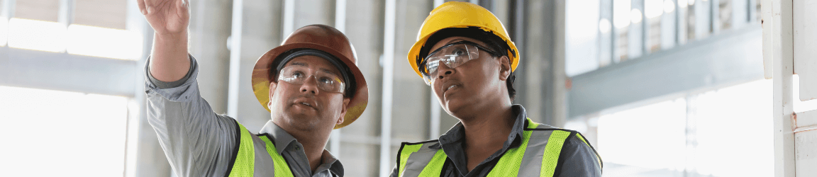 Two construction workers looking at a blueprint