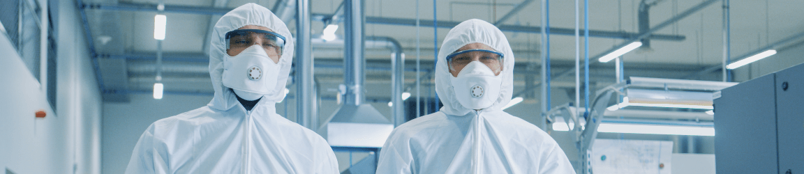 two people wearing white hazmat suits and masks