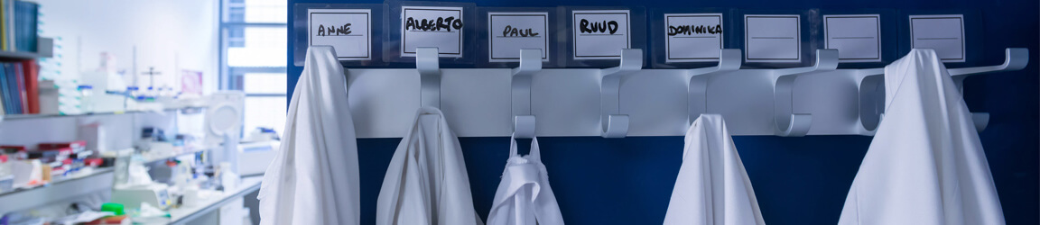 Lab coats hanging under name cards