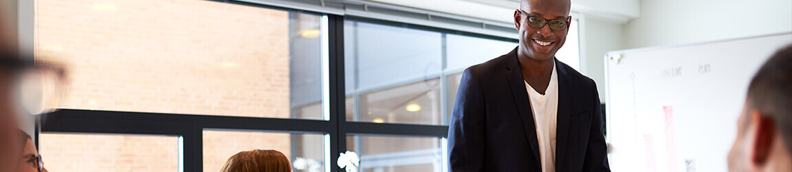 Man leading meeting in a class setting