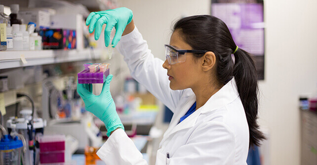 Medical researcher examining specimen in lab