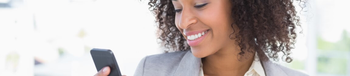 woman holding mobile device smiling