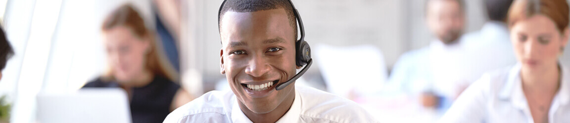 Smiling man working in a call center