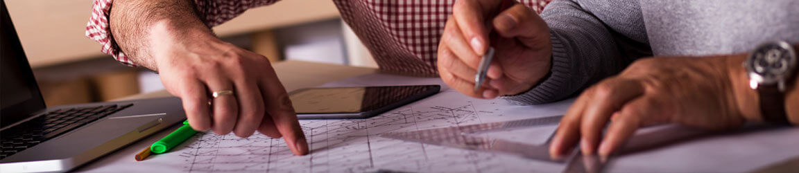 Two person business team drafting plans