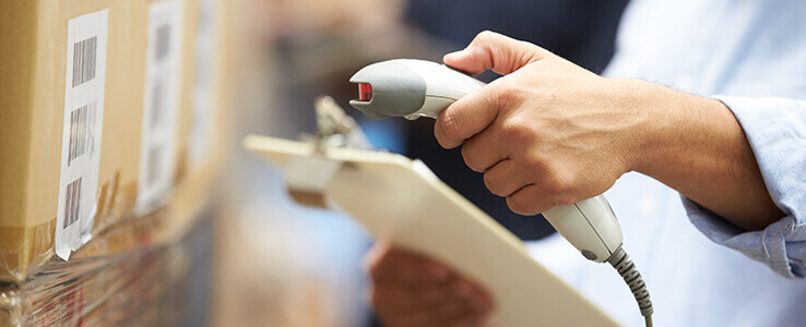 Worker scanning barcode on a box.