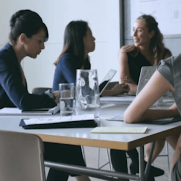 Women working together in a conference space