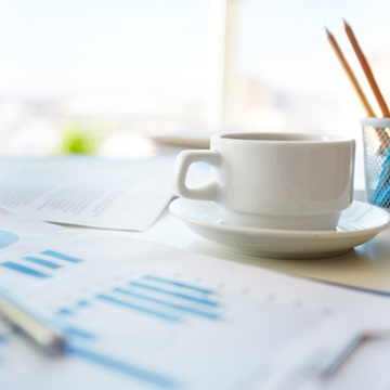Cup and saucer with pencils and charts