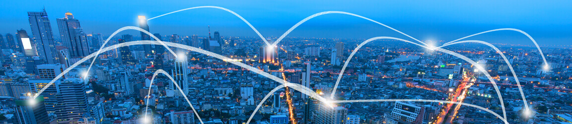 Aerial view of city with curved lines linking various buildings