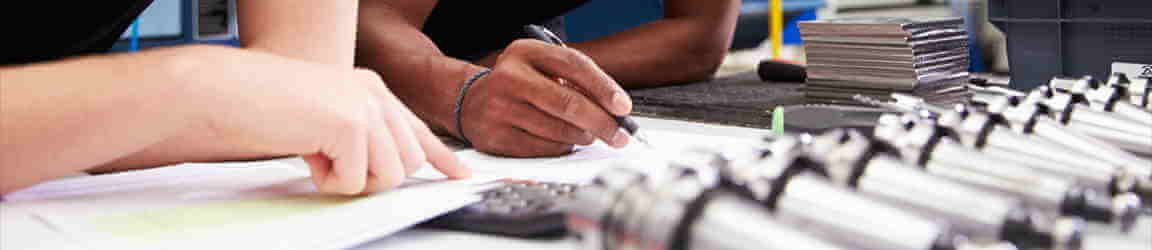 Engineer drafting on table with tools