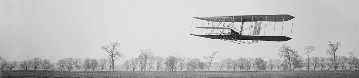 Plane in flight over field