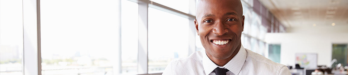 Professional man in an office smiling at the camera