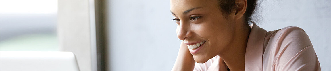 Woman smiling while using laptop